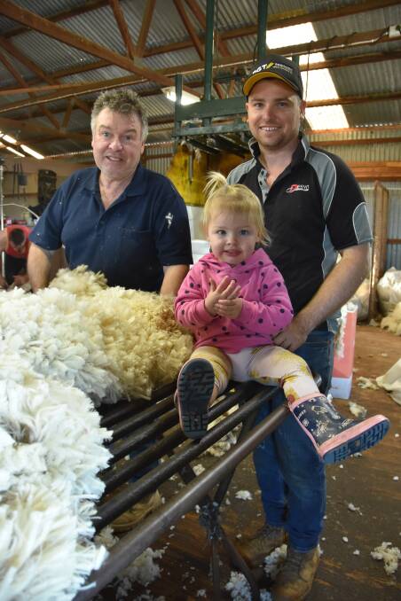 SPIN CYCLE: Three generations of the Walker family, Geoff, Tom and one-year-old Prim were in the shed for shearing last week at their Kulkami property. Geoff says you have to "ride the lows and the highs" of the wool market.