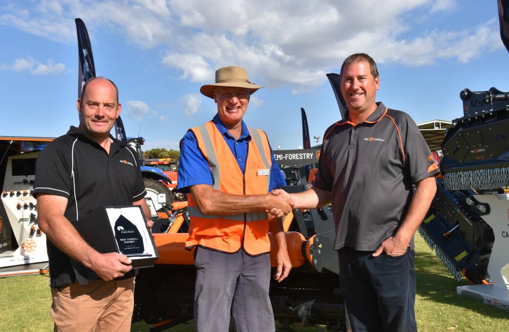 SE Field Days chairman Kevin Baker congratulates TMC Cancela Australia's Ben Stephen and Mitchell Lawson on winning best overall exhibit. Picture by Catherine Miller