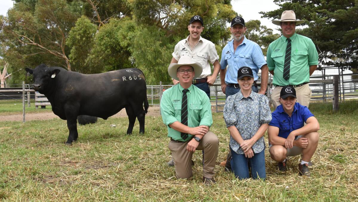 Nutrien stud stock's Gordon Wood (kneeling) and Richard Miller (standing right) with Dylan, Ben, Samantha and Jack Glatz and their lot 17 sale topper- Black Angus Geddes R605 which sold for $38,000.