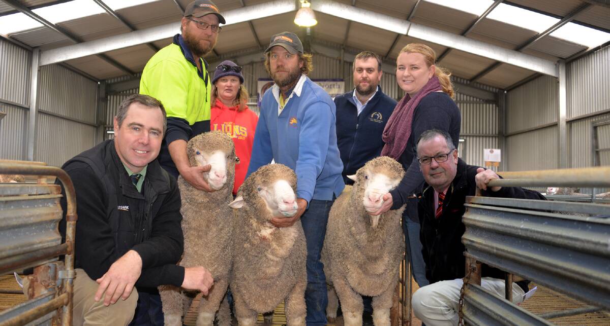 BEST TRIO: Landmark auctioneer Richard Miller with Damien, Sharon and Kenton Heym, Peake, who bought the three $1600 equal top price Poll Merino rams at Carcuma North's annual sale, vendors Grant and Carolyn Johnson and Elders Murray Bridge manager Phil Nagel.