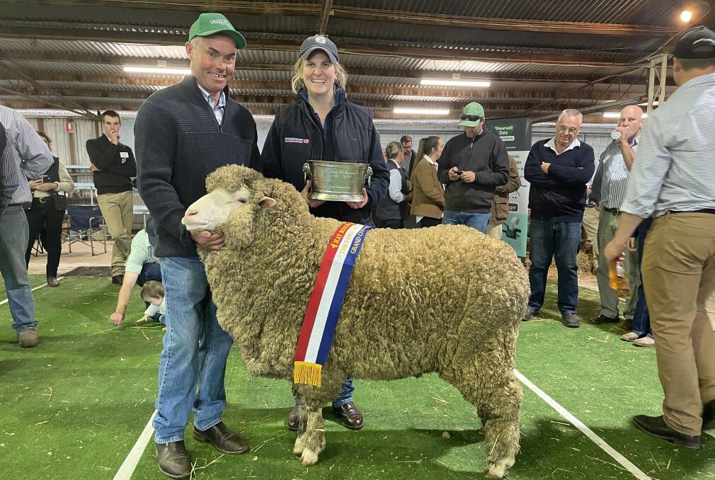 Robert Sullivan, Greenfields, Willalo, with the grand champion ewe winning The Family of Charles Mills Uardry Perpetual Trophy by Emma Bowman, Hay.