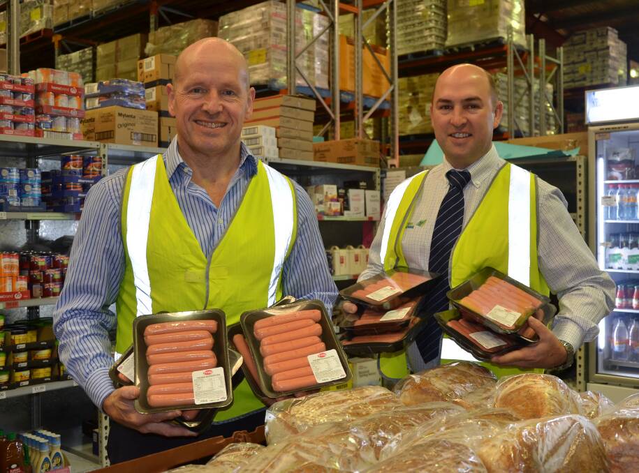 HELPING OUT: Foodbank SA CEO Greg Pattinson with Thomas Foods International chief operating officer David McKay and some donated sausages at Foodbank SA.