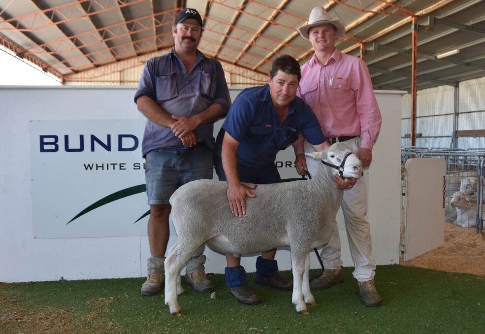Allendale stud's Alastair Day paid the $3000 top price for lot 137- a Poll Dorset ram lamb- being held by Greg Funke and Elders' Nathan McCarthy. Picture by Catherine Miller
