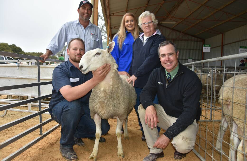 EQUAL TOP: Josh Dowdy holds one of the $2800 rams with Southern Australia Livestock's Alistair Haynes, Josh's fiancee Claire Russell, buyer Pat Stark, Stark Grazing, Naracoorte and Landmark's Richard Miller.