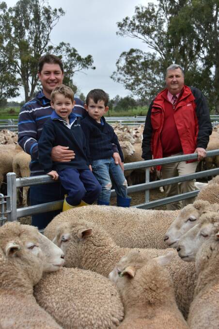 Buyer of the $476 record-breaking ewes Greg Funke (pictured with sons Lachy, 5 and Ben, 3 and agent Elders Bordertown branch manager Brenton Henriks.