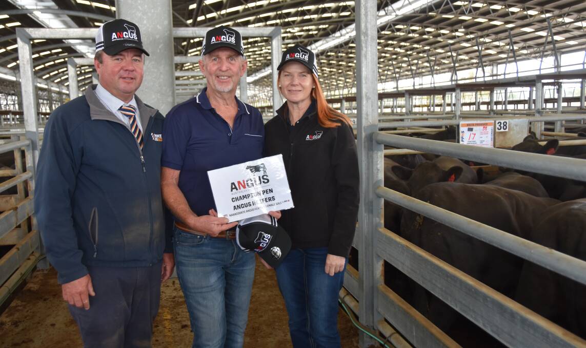Spence Dix & Co's Jono Spence and Angus Australia board member Simone Bond congratulate Steve Rathjen, Delta Produce, Sherwood (middle) on winning the champion pen of heifers. Pictures by Catherine Miller
