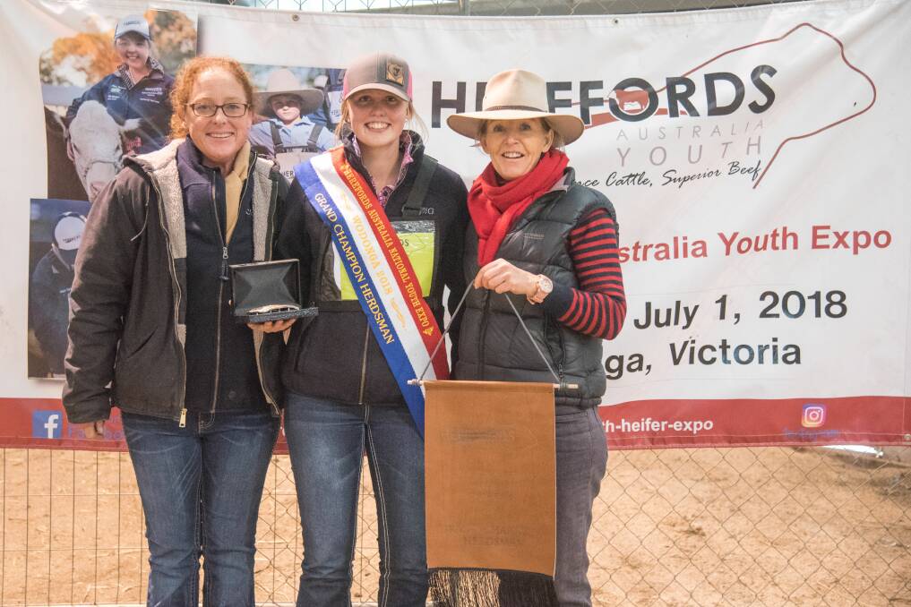 CHAMPION HERDSMAN: Judges Sophie Holt and Kerrie Sutherland congratulate Eleni Fogden (middle) on winning the herdsman award. Photo: Emily H Photography
