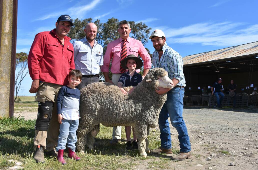TYLER'S PICK: Lee Slape, Coomandook, and sons Isaac and Tyler, with their agent Luke Schreiber, bought the $7000 top price ram. They are with Elders auctioneer Laryn Gogel and Flairdale's Matt Lehmann.