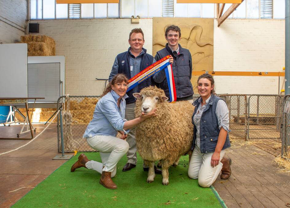 Leslie Brewer, Dusty Jones and Beau Gemmell, Radstock Romney stud, Strathalbyn, with their champion ram being sashed by judge Josh Wiltshire.