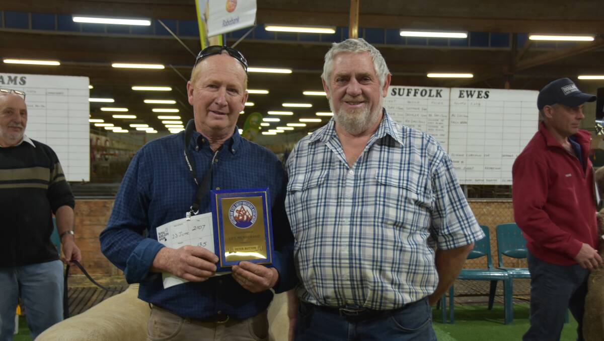 Yorke Peninsula breeder Peter Button receives a life membership plaque from Australian Stud Sheep Breeders Association president Neil Kroehn.