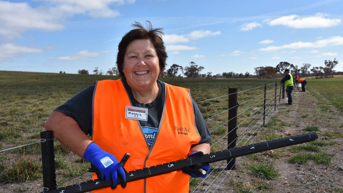 BlazeAid volunteer and former local Maggie Paltridge, who is now based in Perth, attaches droppers to a fence at Avenue Range.