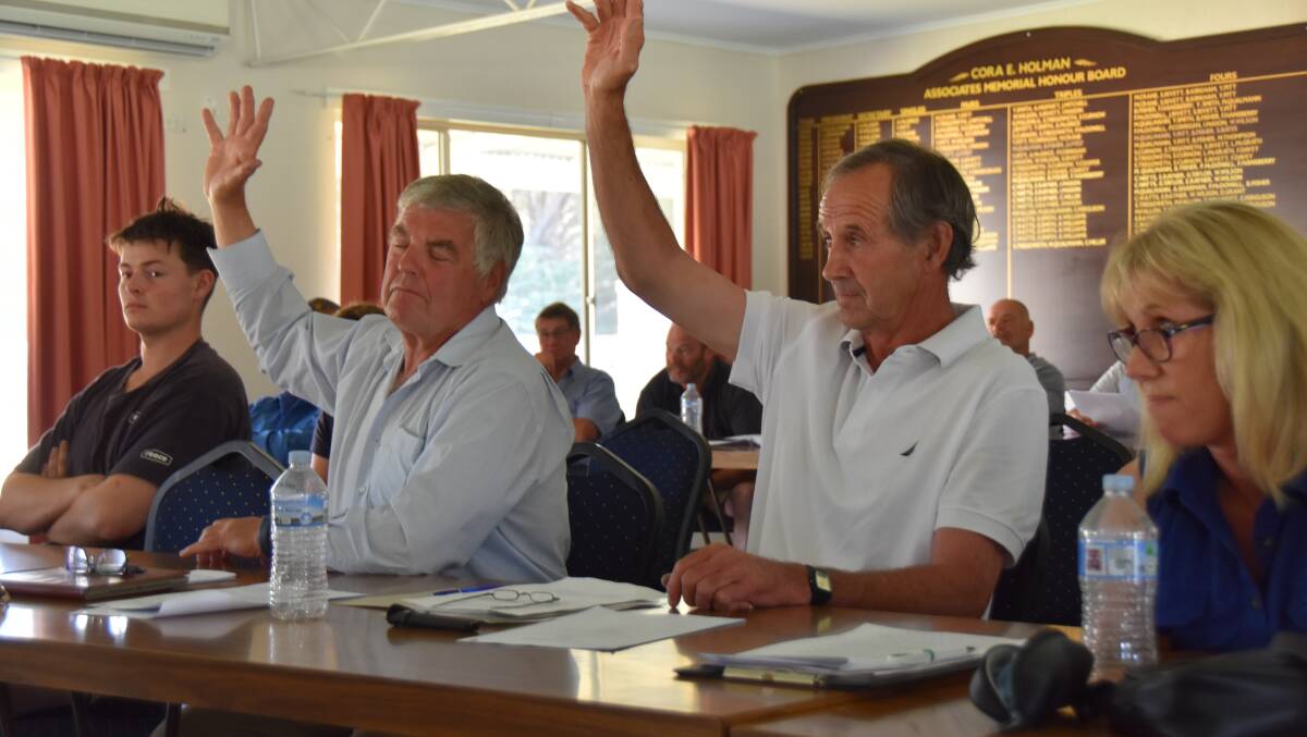 Mount Burr prime lamb producer Mitch Williams and Tantanoola producer Peter Altschwager vote in support of a motion calling for the eID steering committee to be disbanded. Pictures by Catherine Miller.