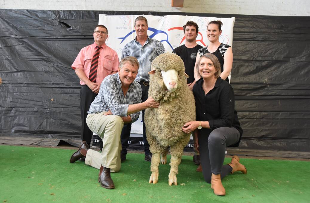 STAR LOT: (back) Elders' Tony Wetherall, Paul Cousins and buyers Jesse and Courtney Hull, with Geoff and Bernadette Davidson holding their $70,000 'Lightning' ram.