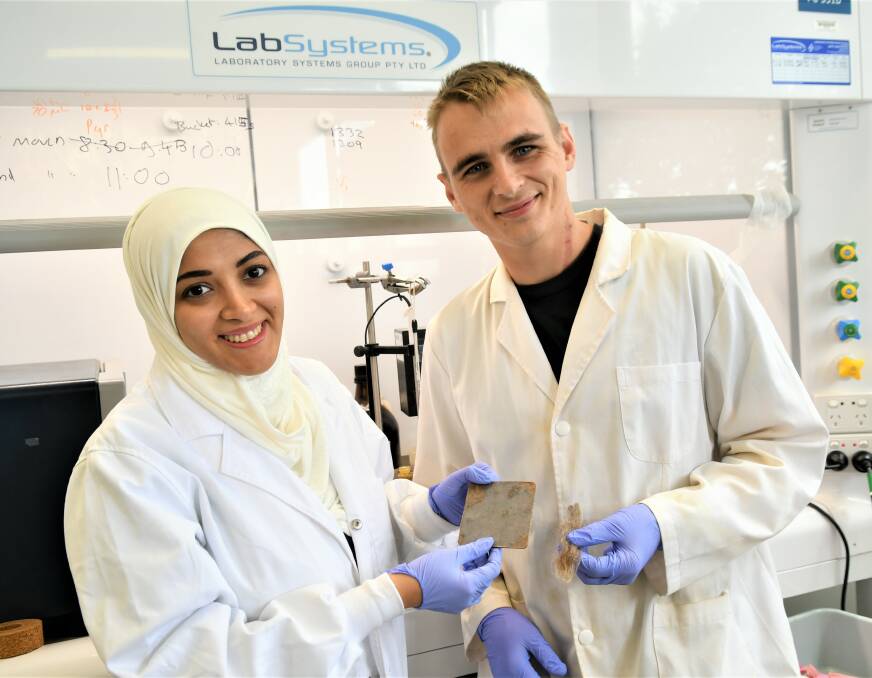 International masters student Ms Israa Bu Najmah and Flinders University postgrad Nic Lundquist with samples of the composite and Border Leicester fleece in the Chalker organic chemistry laboratory at Flinders University. Picture: supplied.