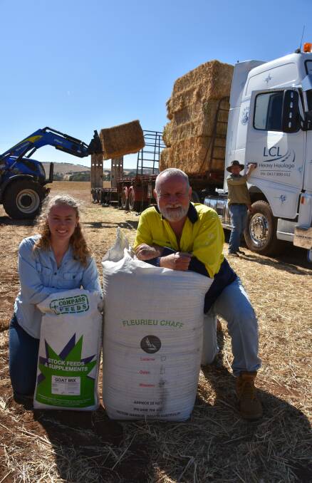 SUPPORT: SA Dairyfarmers' Association's Ashleigh Pulford and John Elferink at the Livestock SA hay depot in Cape Jervis, with Peter Taylor, LCL Heavy Haulage, Adelaide.