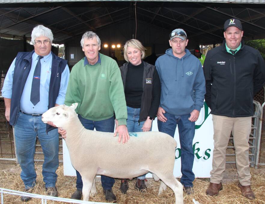GOOD LOOKING: Tony Clark, Wardle Co; Geoff and Tania Stock; top price ram buyer Des Detmar, Warooka; and Andrew Parsons, Nutrien.