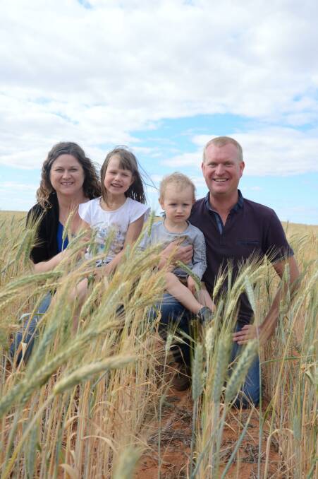 The Nitschke family of Steph, Lucy, 5, Jude, 2, and Tim in a paddock that has been continuously cropped for 50 years, currently sown to triticale. 
