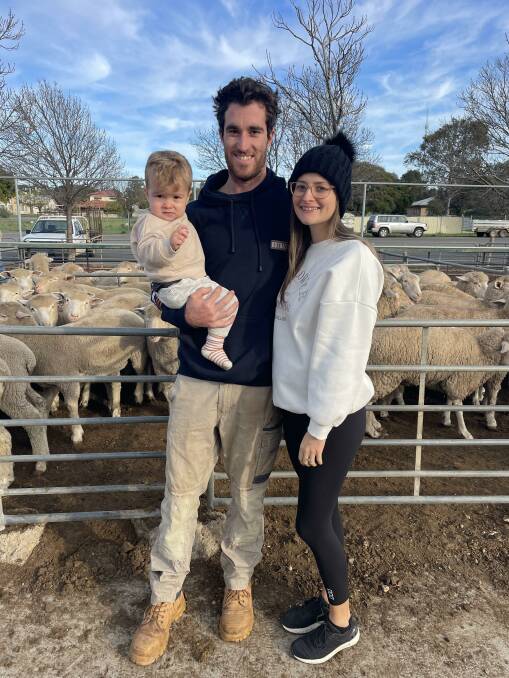 Luke McSwain, Merbein South, Vic, holding Chase with partner Ella Smith at Ouyen sheep market on Thursday.