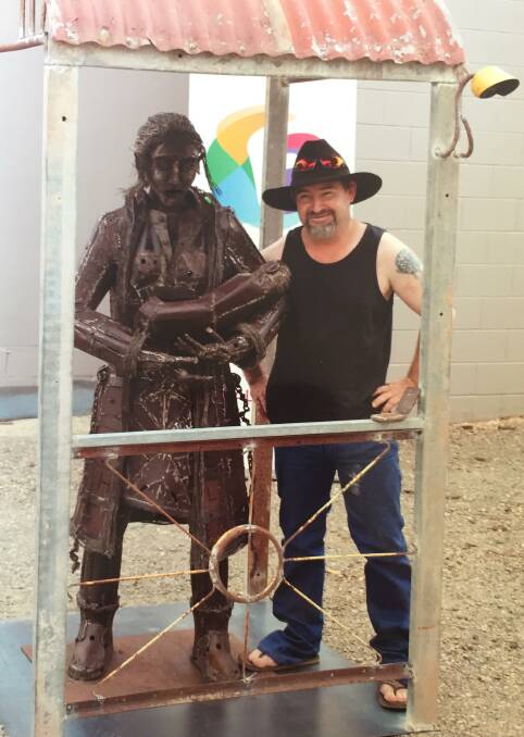 FARMER'S WIFE: Trent Stewart with his scrap metal art piece 'The Farmer's Wife'.