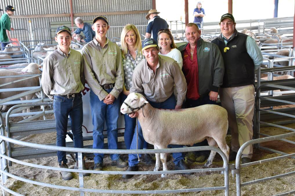 Alex, Brett, Deb and Andrew Krieg (holding the ram), all of Aylesbury Farm, with top price buyers Julie and Darren Crouch and James McInally, Landmark Karoonda