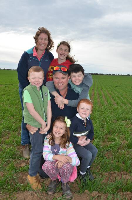 TOP CROP: Liz and Brad Moyle, with children (back) Isabelle, 11, (centre) Timothy, 6, Samuel, 9, (front) Rachel, 7, and Matthew, 4, in Mace wheat sown on May 15.