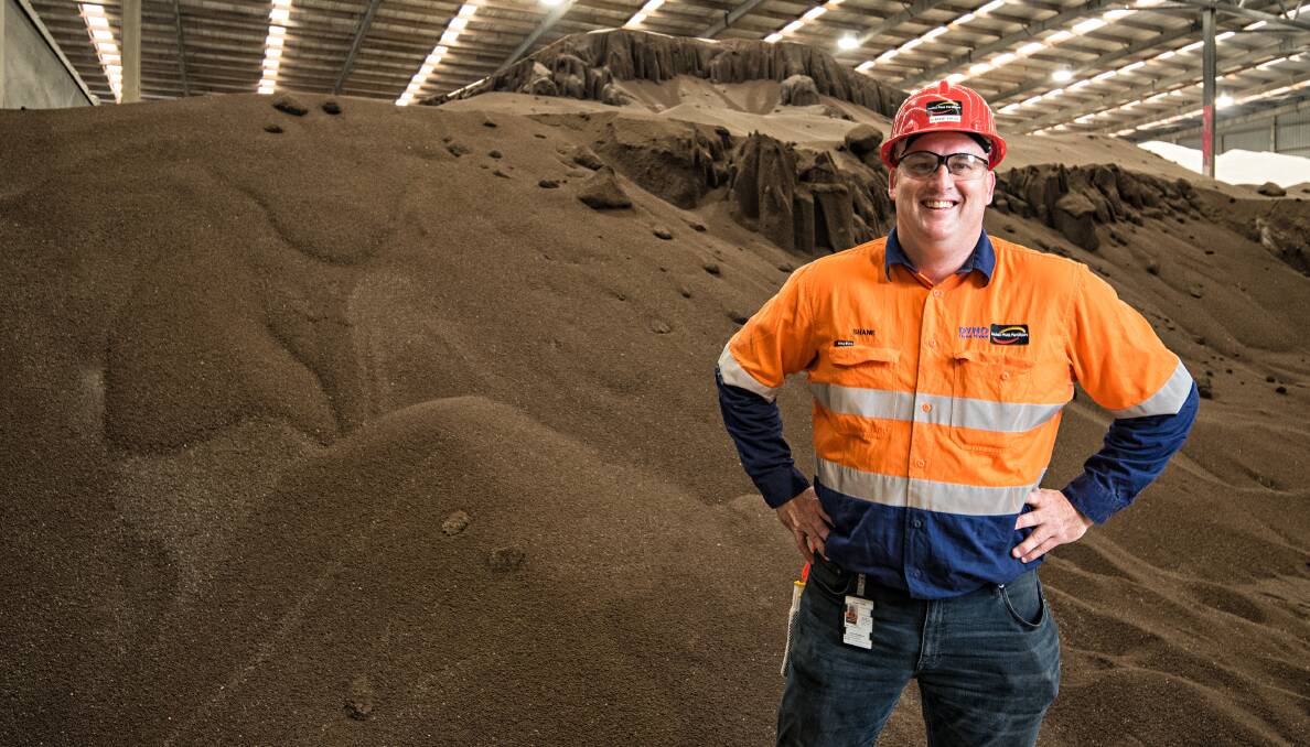 Shane Hase, Incitec Pivot's Geelong distribution centre manager, with the piles of fertiliser the company has in stock.