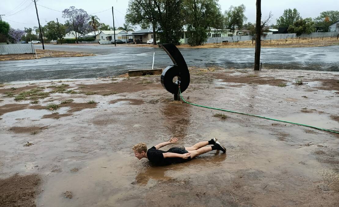 A young fella makes the most of the wet weather at Nyngan in the Orana in NSW. Photo: contributed.
