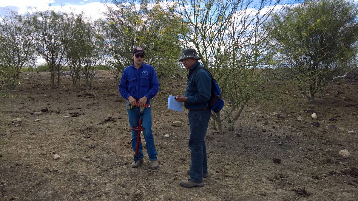 Professor Vic Galea and Joe Banks addressing a trial site at NAPCo's Alexandria Station in the Northern Territory.