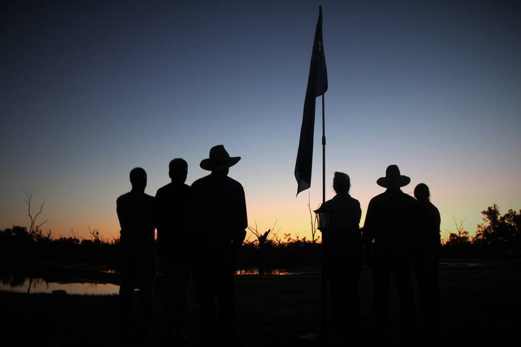 Australians take the opportunity to honour their servicemen and women wherever they are on Anzac Day, including this group at Lara Wetlands, south of Barcaldine.