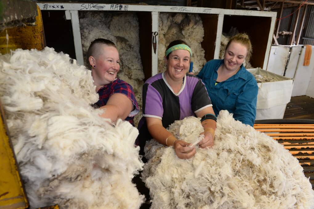 Shearers Jess Patterson and Cynthia Southwell, "Box Hill", Rye Park, and rouseabout Clare Hanson, Yass, shearing at "Clanmarra", Bowning. 