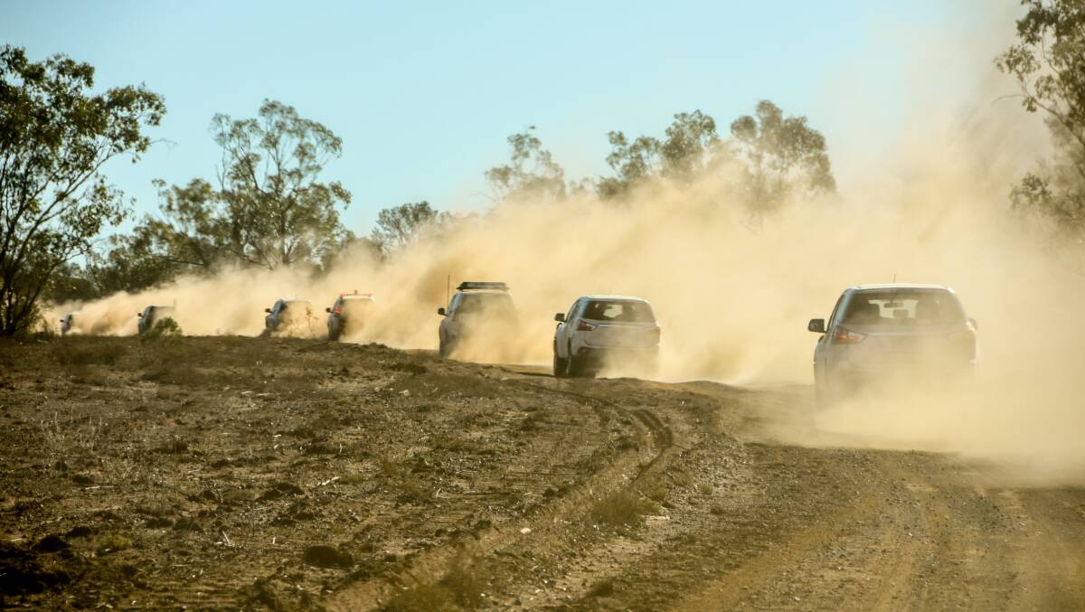 A convoy of cars, including the PM's, entering a drought-stricken property at Charleville in south west Queensland this week. Picture by Lucy Kinbacher 