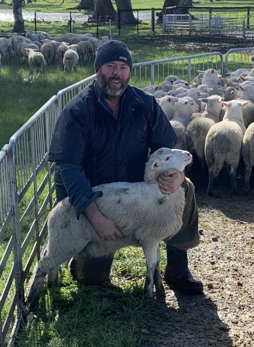 LAMB PRODUCTION: Jarrad Simcock with one of his Australian White lambs. Lambs are usually sold on-hooks, to dress out at 20kg to 22kg.