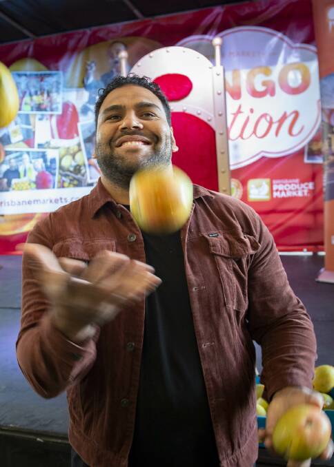 SKILLS: Former NRL player and Your Local Fruit Shop ambassador, Sam Thaiday, shows off his mango skills. Mr Thaiday scored first place in the hotly-contested Mango Seed Squeeze competition.