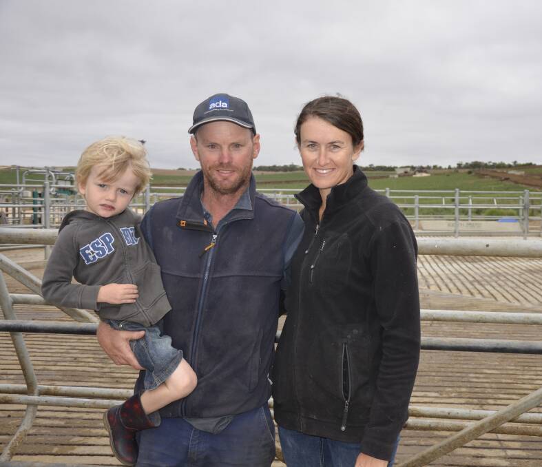 LOOKING FORWARD: Glenn and Geraldine Dohnt with four-year-old son Oren in their 800 cow yard at Monteith, with the feed pad in the background. The Dohnts say the drought instigated some big changes in their operation.