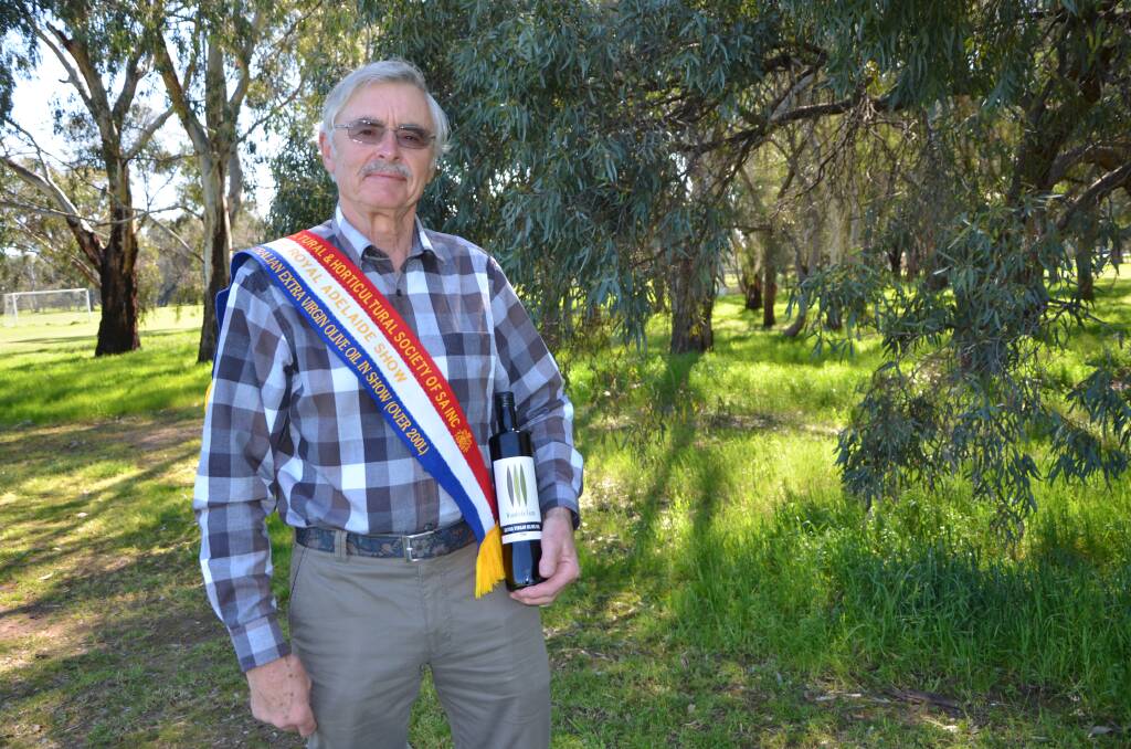 Ron Baker, Woodside Farm, Woodside, with his gold medal-winning extra virgin olive oil, which was named the best SA oil in the Royal Adelaide Show.
