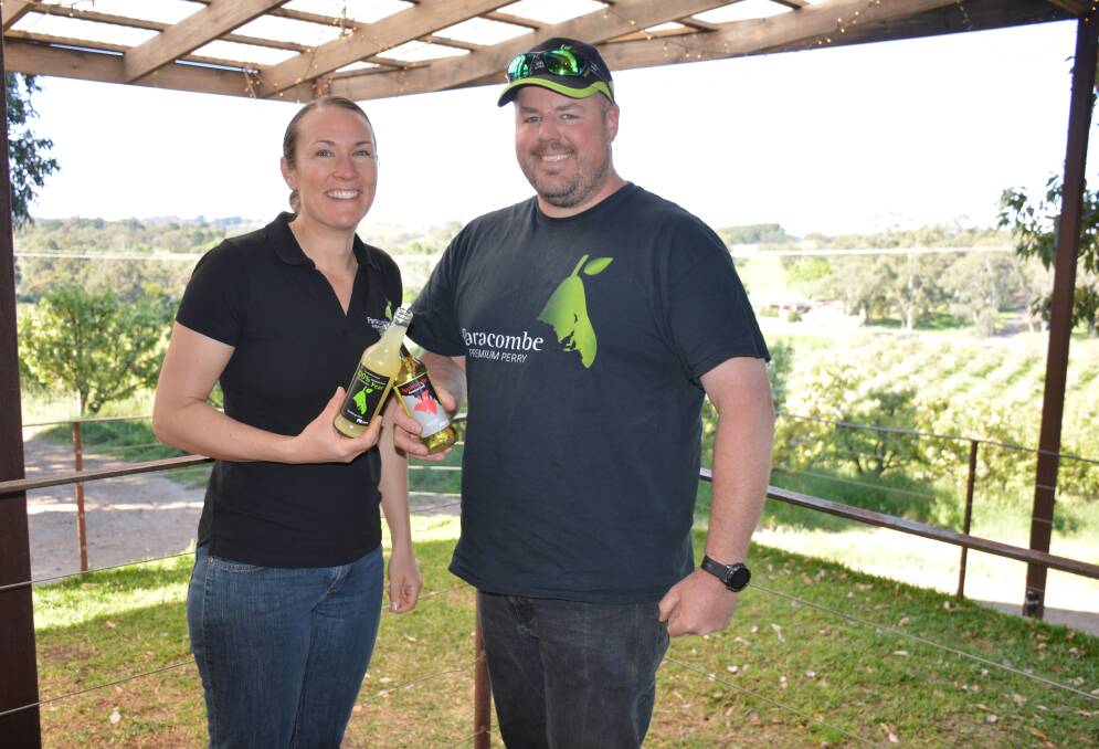 Paracombe Premium Perry founders and Chamberlain Orchards operators Amelia and Damian McArdle in the "shed door", overlooking their orchard. Picture by Elizabeth Anderson