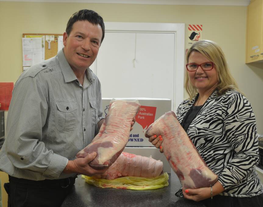 CRACKLING AID: Riverton pork producer Matthew Greenslade and Catherine House fundraising and events manager Jaylee Cooper with the first delivery of an ongoing donation of SA pork.