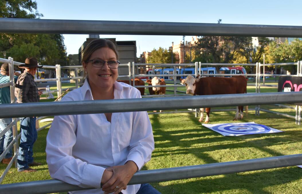 Megan McLoughlin with Dolly the cow in Victoria Square, Adelaide, ahead of the South Australian state election.