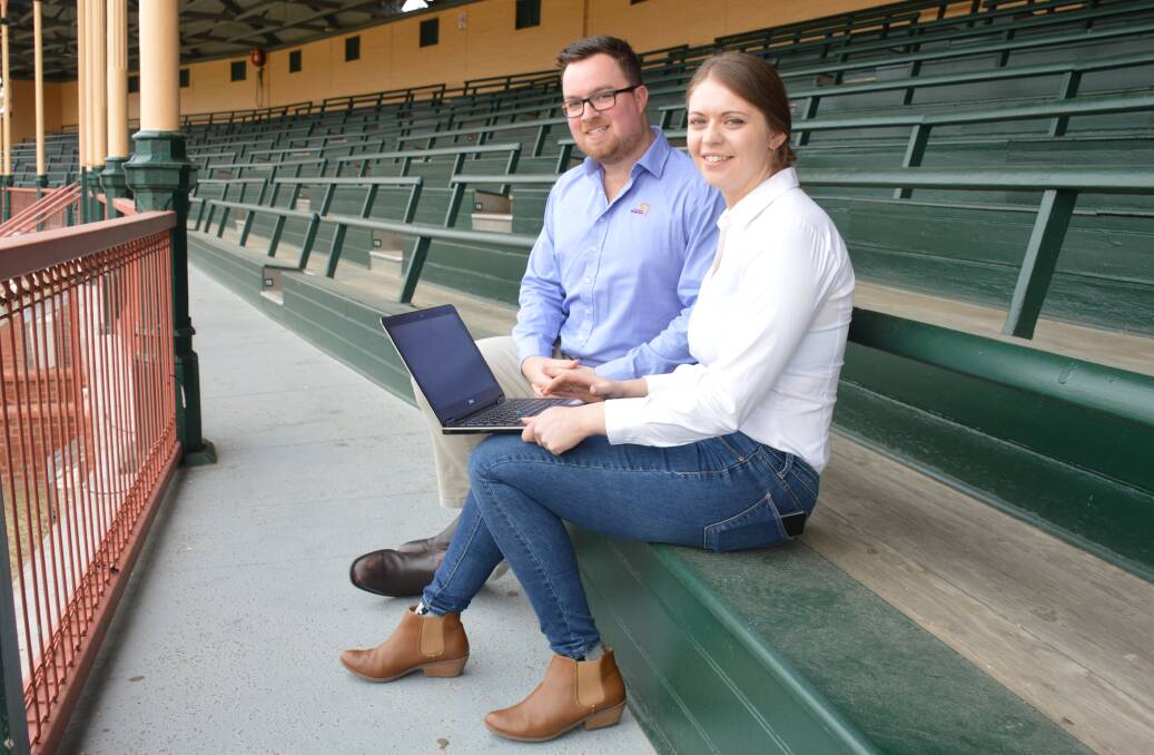 Royal Adelaide Show brand manager Ben Steggall and marketing manager Kirrilee Hay check out The Show At Home website, from the showground grandstand.