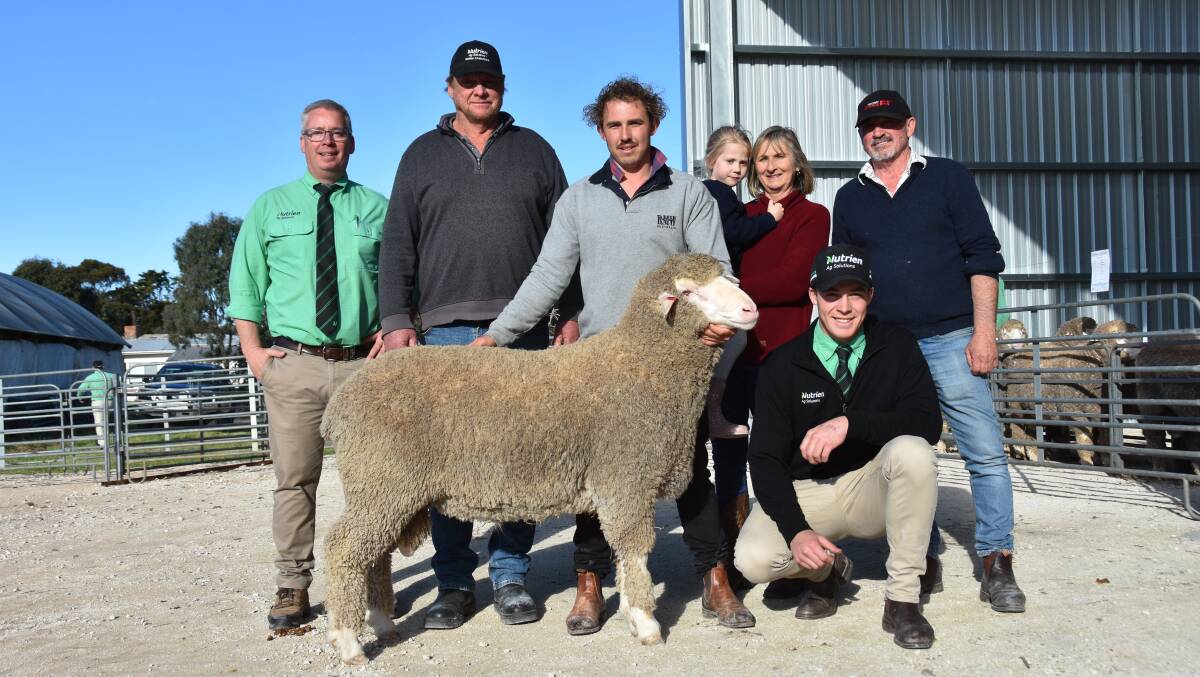 Nutrien auctioneer Gordon Wood, top price buyer Glen Farr, Loxton, Devon Ridgway holding the $10,000 ram, Karen Ridgway holding granddaughter Layla Obst, David Ridgway and at front Nutrien Bordertown's Jack Guy. Picture by Catherine Miller 