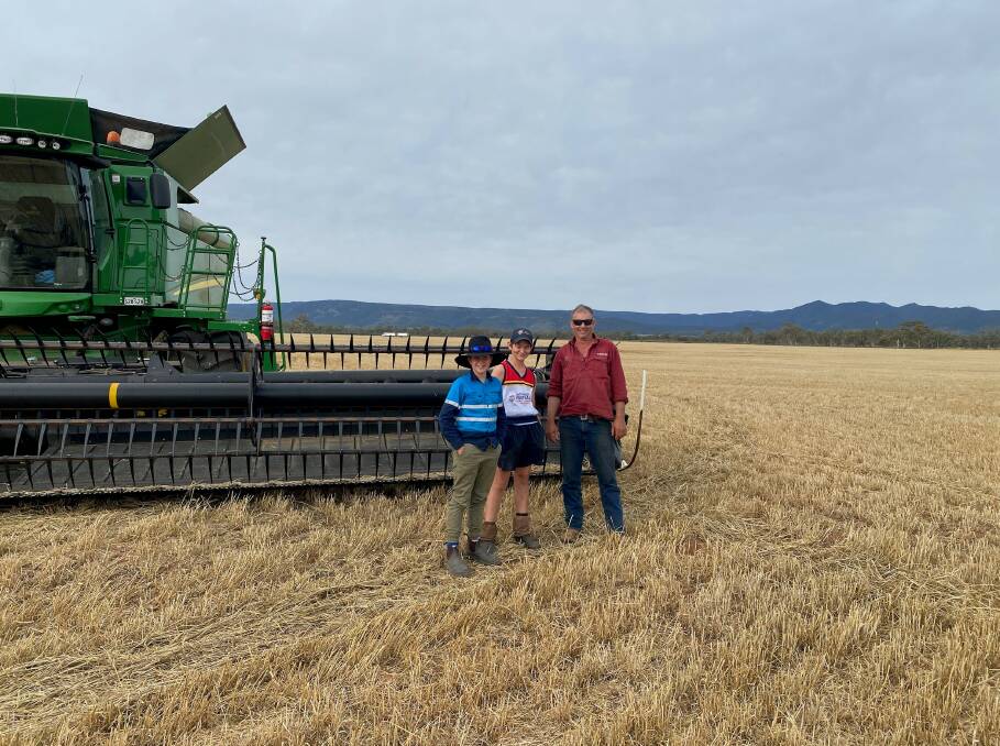 Cousins Fletch Bussenschutt and Angus Bussenschutt, with Angus' father Sam Bussenschutt in their paddock after the first load delivery of barley to Viterra.