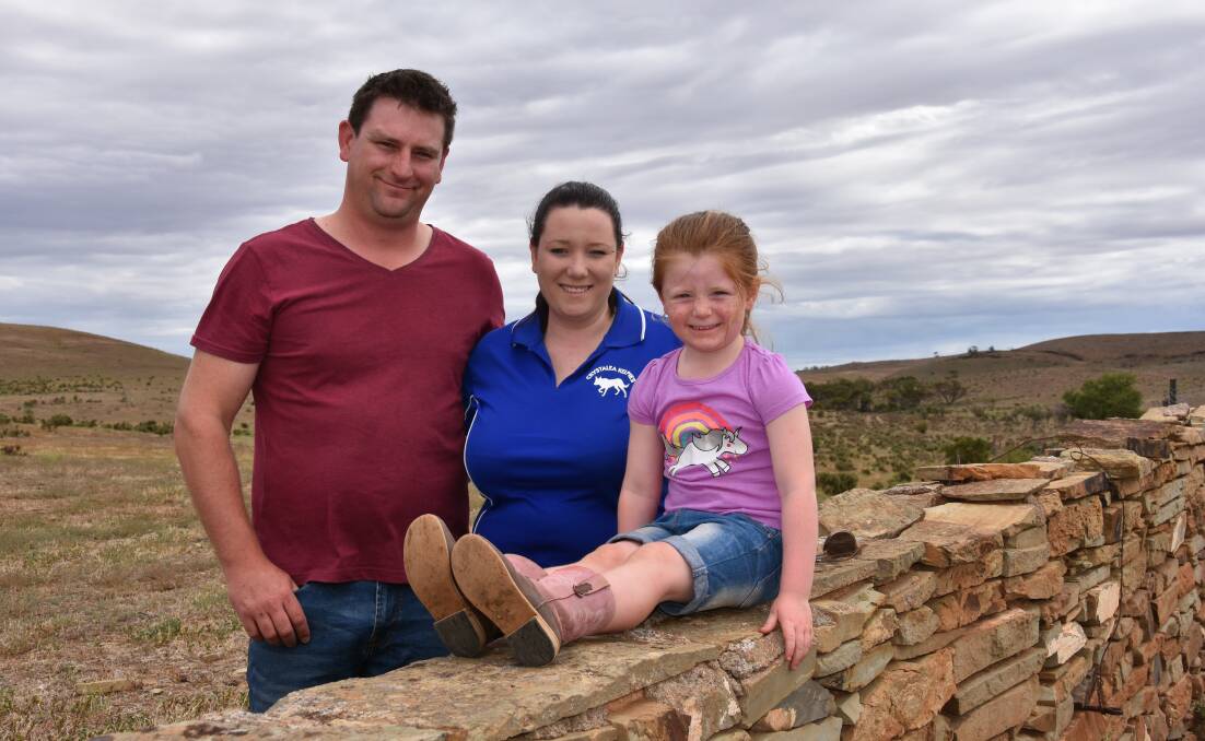 Shane, Anna and Scarlett Hooper, at Orroroo where rain has returned green cover to the country.
