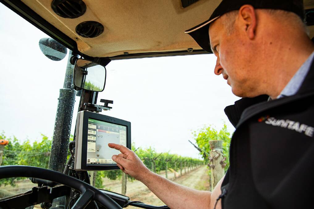 STATE OF THE ART: Warren Lloyd, SMART farm project manager, SuniTAFE, in the John Deere 5085GF tractor that has been fitted with JDLink and Generation 4 CommandCenter.
