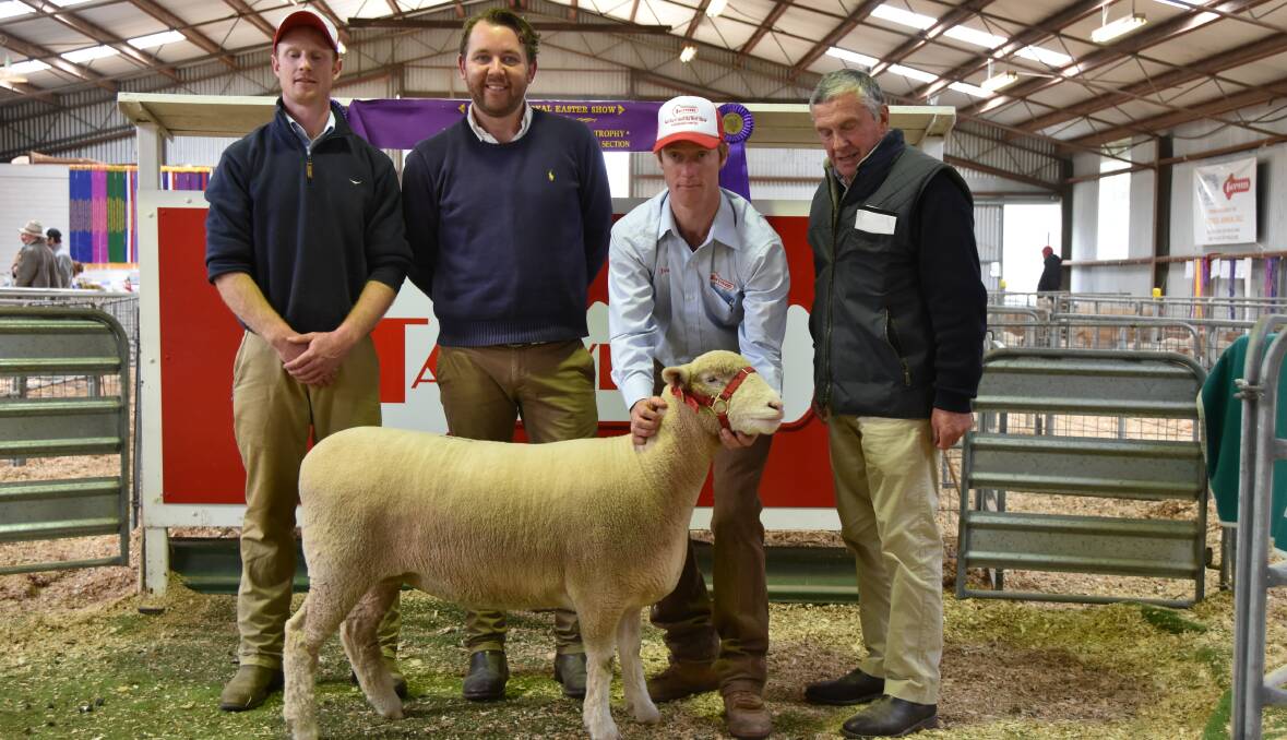 A SPECIAL EWE: Ross Gilmore, auctioneer Miles Phitzner, James Gilmore and buyer, Kerry Davis, Boho, Victoria, with the top-priced ewe. 