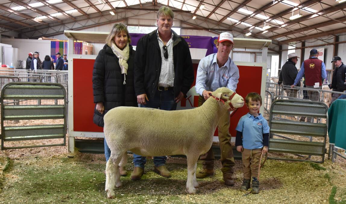 SALE TOPPER: Craig Graham and Deb Stone, Sandilands, South Australia, with their top-priced ram held by James Gilmore with his son, Hudson, 3. 