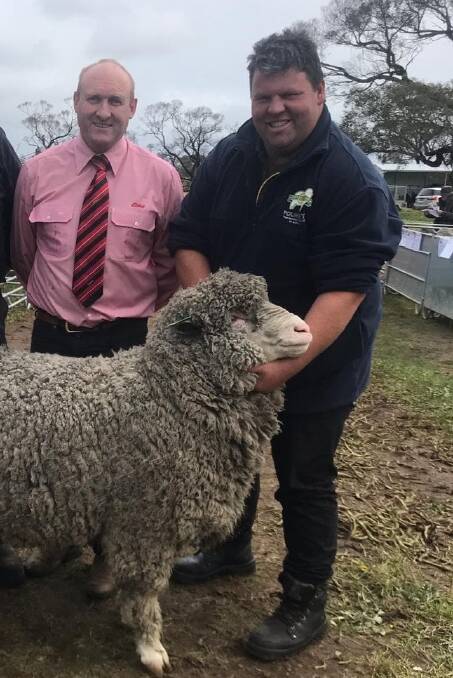 ELDERS MAN: Greg Downing of Elders with Jared McArdle and his top selling ram from the Taljar stud's 2020 sale. 