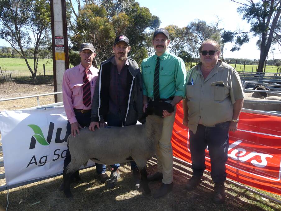TOP PRICE: Bidder Daniel Crane from MacGillivray with his top-priced Suffolk ram purchased at the Skallemaro auction, flanked by stock agent Stuart Were from Elders and auctioneer Dusty Cross from Nutrien. Photo: Stan Gorton 