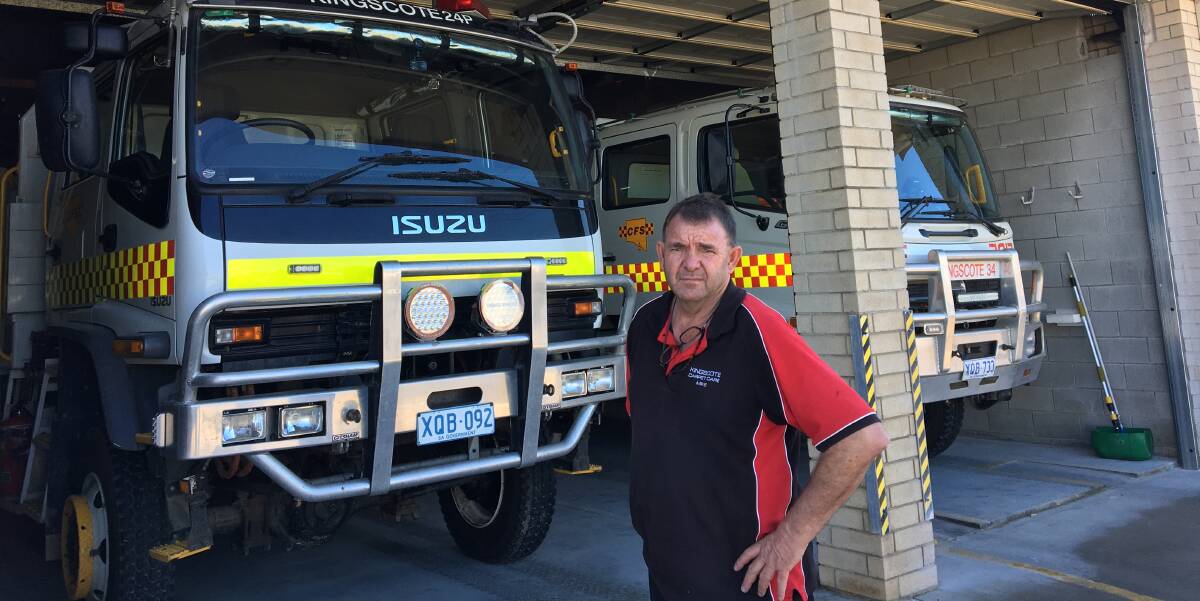  Kingscote Country Fire Service brigade captain Michael Swayne in front of the new automatic roller doors and a repaired Kingscote 24 appliance. 