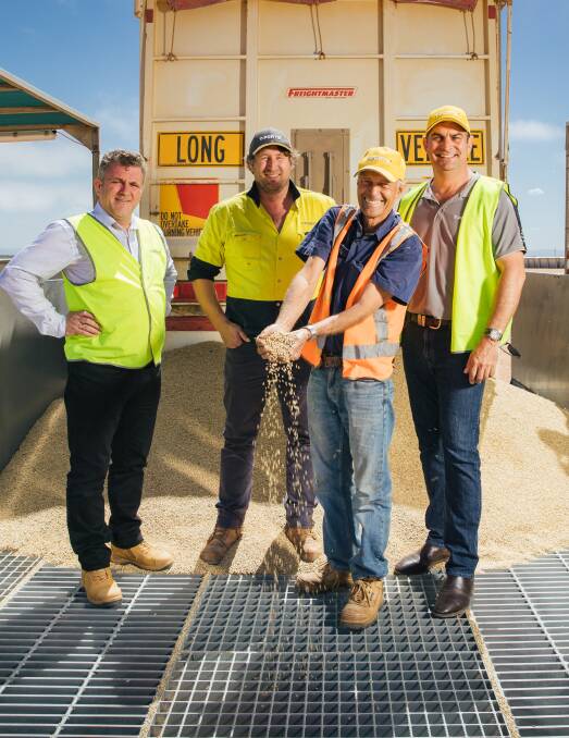 GRAIN: Carrier Jack Kaden (second right) with Kieran Carvill, Jeff Cowan and Tim Gurney from T-Ports and the first load of grain received. Photo: Robert Lang Photography