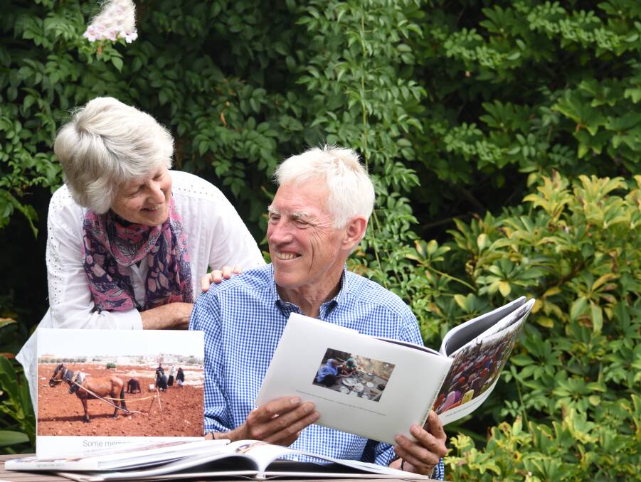 LOOKING BACK: Australia Day award recipient David Coventry (right) and his wife Margaret look back at some books created by David on his overseas agricultural ventures.